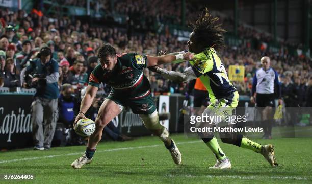 Gareth Owen of Leicester Tigers holds off Marland Yarde of Sale Sharks to score a try during the Aviva Premiership match between Leicester Tigers and...