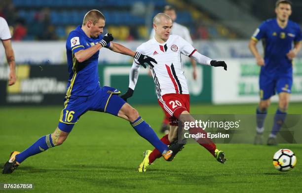 Yevgeni Makeyev of FC Rostov Rostov-on-Don vies for the ball with Pavel Komolov of FC Amkar Perm during the Russian Premier League match between FC...