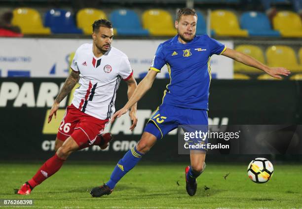 Sverrir Ingi Ingason of FC Rostov Rostov-on-Don vies for the ball with Braun Forbs of FC Amkar Perm during the Russian Premier League match between...