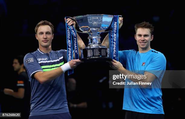 Henri Kontinen of Finland and John Peers of Australia lift the trophy following victory following the doubles final against Marcelo Melo of Brazil nd...