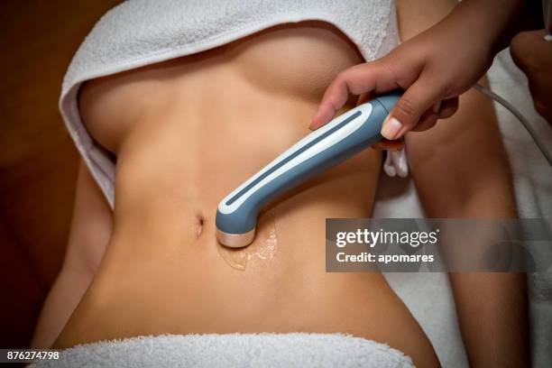 ultrasound treatment for fat reduction on abdomen - fat massage stock pictures, royalty-free photos & images