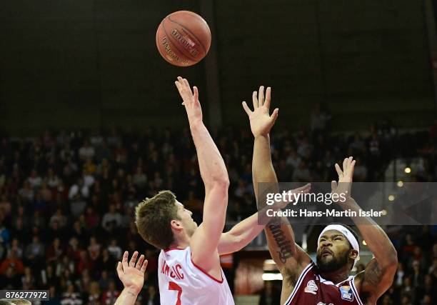 Aleksej Nikolic of Brose Bamberg shoots against Devin Booker of FC Bayern Muenchen during the BBL Basketball Bundesliga match between FC Bayern...