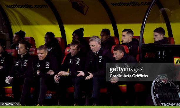 David Moyes of West Ham United discusses with his assistants Stuart Pearce and Billy McKinlay on during the Premier League match between Watford and...