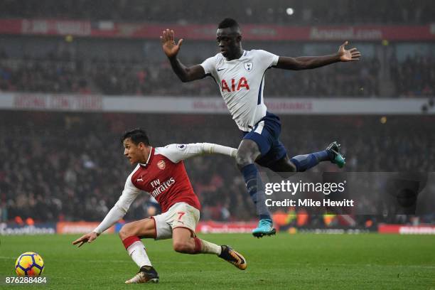 Alexis Sanchez of Arsenal is challenged by Davinson Sanchez of Tottenham during the Premier League match between Arsenal and Tottenham Hotspur at...