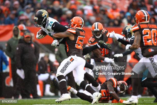 Christian Kirksey of the Cleveland Browns tackles T.J. Yeldon of the Jacksonville Jaguars in the first half at FirstEnergy Stadium on November 19,...