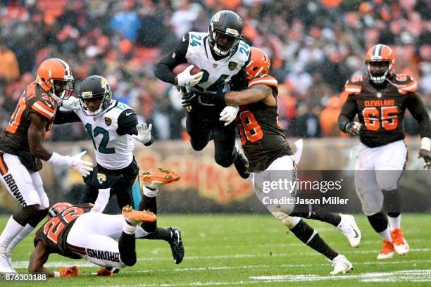 Christian Kirksey of the Cleveland Browns tackles T.J. Yeldon of the Jacksonville Jaguars in the first half at FirstEnergy Stadium on November 19,...