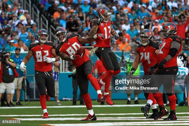 Howard celebrates with teammate Mike Evans of the Tampa Bay Buccaneers after scoring a touchdown during the second quarter against the Miami Dolphins...