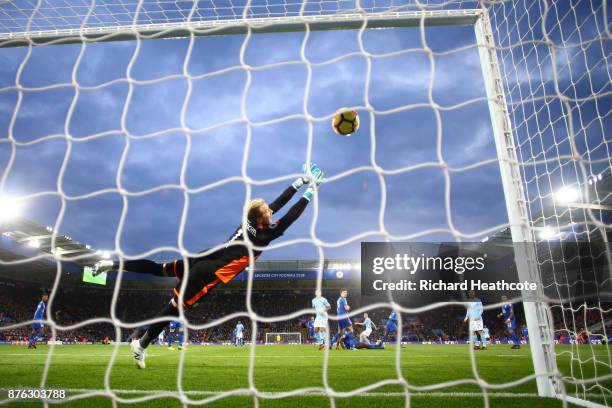 Kasper Schmeichel of Leicester City dives in vain as Kevin De Bruyne of Manchester City scores his side's second goal during the Premier League match...