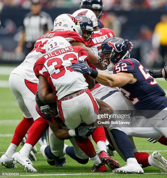 Kerwynn Williams of the Arizona Cardinals is tackled by Brian Peters of the Houston Texans in the second quarter at NRG Stadium on November 19, 2017...