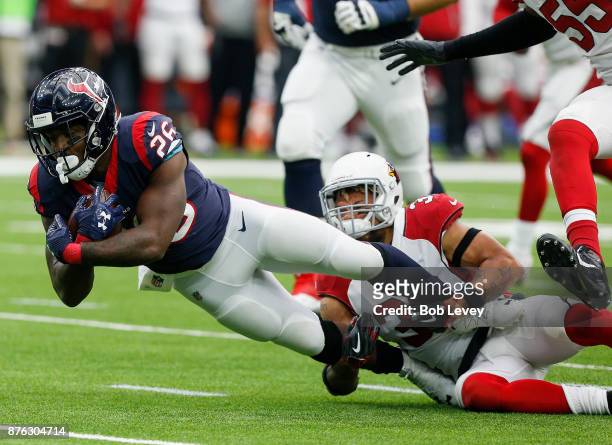Lamar Miller of the Houston Texans is tackled by Tyrann Mathieu of the Arizona Cardinals at NRG Stadium on November 19, 2017 in Houston, Texas.