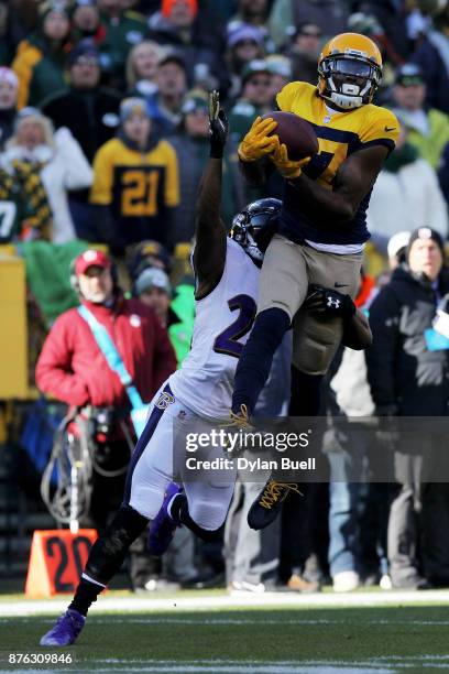 Davante Adams of the Green Bay Packers makes a catch while being guarded by Brandon Carr of the Baltimore Ravens in the first quarter at Lambeau...