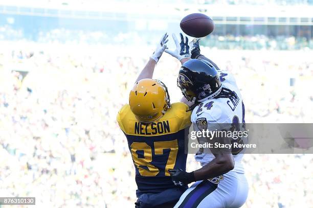 Brandon Carr of the Baltimore Ravens defends a pass intended for Jordy Nelson of the Green Bay Packers during the first half at Lambeau Field on...