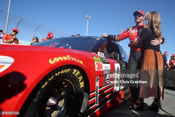Dale Earnhardt Jr., driver of the AXALTA Chevrolet, and his wife Amy take part in pre-race ceremonies for the Monster Energy NASCAR Cup Series...
