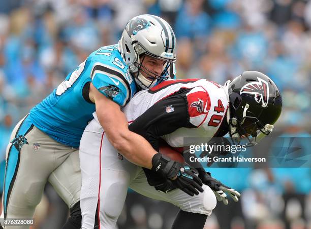 Luke Kuechly of the Carolina Panthers tackles Derrick Coleman of the Atlanta Falcons during their game at Bank of America Stadium on November 5, 2017...