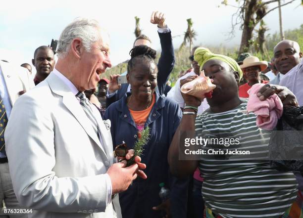 Resident plays a conch shell as Prince Charles, Prince of Wales visits Bellevue Chopin Farm to discuss the impact of Hurricane Maria on local...