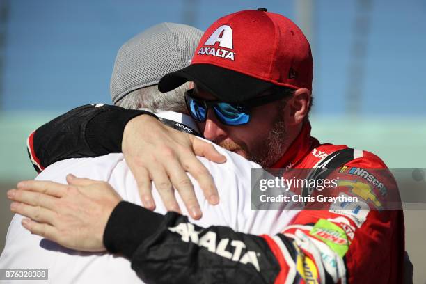 Dale Earnhardt Jr., driver of the AXALTA Chevrolet, hugs Rick Hendrick during pre-race ceremonies for the Monster Energy NASCAR Cup Series...