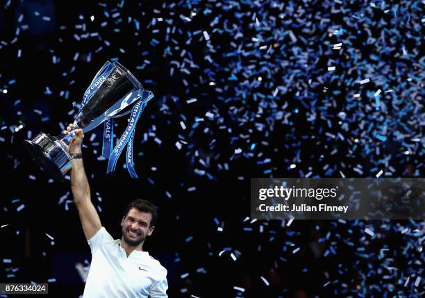 Grigor Dimitrov of Bulgaria lifts the trophy as he celebrates victory following the singles final against David Goffin of Belgium during day eight of...