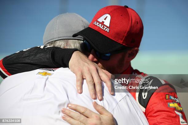 Dale Earnhardt Jr., driver of the AXALTA Chevrolet, hugs Rick Hendrick during pre-race ceremonies for the Monster Energy NASCAR Cup Series...