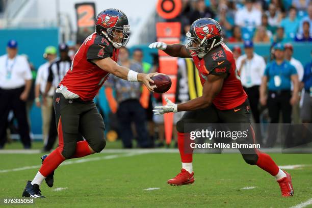 Ryan Fitzpatrick handsoff to Doug Martin of the Tampa Bay Buccaneers during the third quarter against the Miami Dolphins at Hard Rock Stadium on...