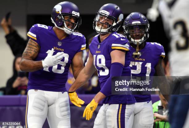 Adam Thielen of the Minnesota Vikings, Michael Floyd, and Jerick McKinnon celebrate after scoring a touchdown in the fourth quarter of the game...