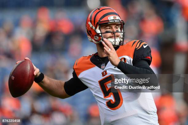 Quarterback AJ McCarron of the Cincinnati Bengals throws as he warms up before a game against the Denver Broncos at Sports Authority Field at Mile...