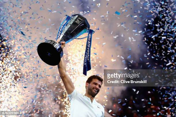 Grigor Dimitrov of Bulgaria lifts the trophy as he celebrates victory following the singles final against David Goffin of Belgium during day eight of...