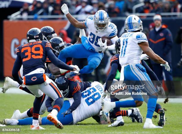 Jamal Agnew of the Detroit Lions jumps over players while carrying the football in the third quarter against the Chicago Bears at Soldier Field on...