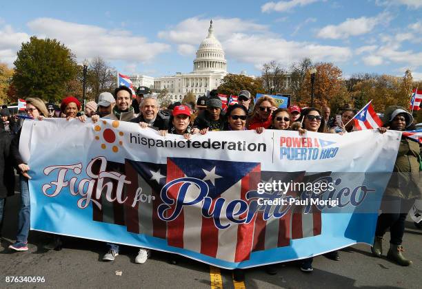 Lin-Manuel Miranda and his father, Luis A. Miranda Jr., attend a Unity for Puerto Rico march on Capitol Hill on November 19, 2017 in Washington, DC.