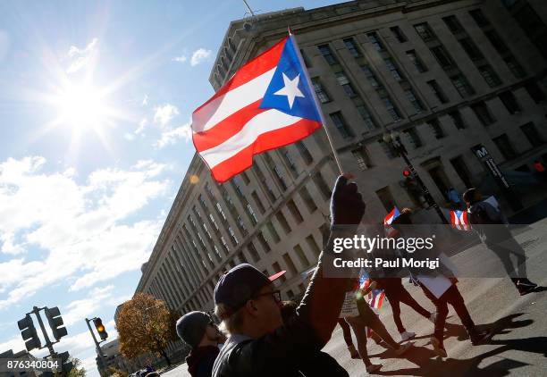 People wave flags during the Unity for Puerto Rico march on Capitol Hill on November 19, 2017 in Washington, DC.