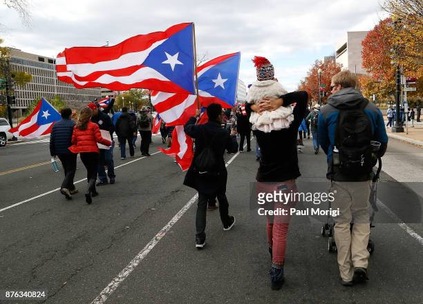 People wave flags during the Unity for Puerto Rico march on Capitol Hill on November 19, 2017 in Washington, DC.