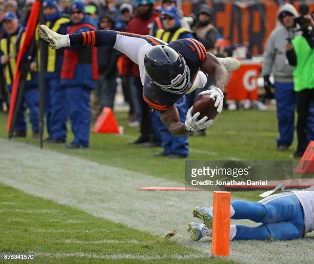 Tarik Cohen of the Chicago Bears dives across the end zone to score a touchdown against the Detroit Lions at Soldier Field on November 19, 2017 in...