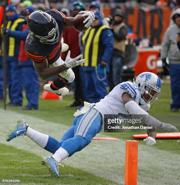 Tarik Cohen of the Chicago Bears is hit by Glover Quin of the Detroit Lions as he runs to the end zone at Soldier Field on November 19, 2017 in...