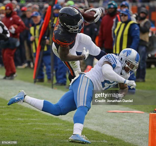 Tarik Cohen of the Chicago Bears is hit by Glover Quin of the Detroit Lions as he runs to the end zone at Soldier Field on November 19, 2017 in...