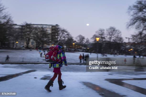 Deutschland Germany Berlin Ein Schulkinder spaziert Ã¼ber eine gefrorene EisflÃ¤che im Weinbergspark in Berlin-Mitte.