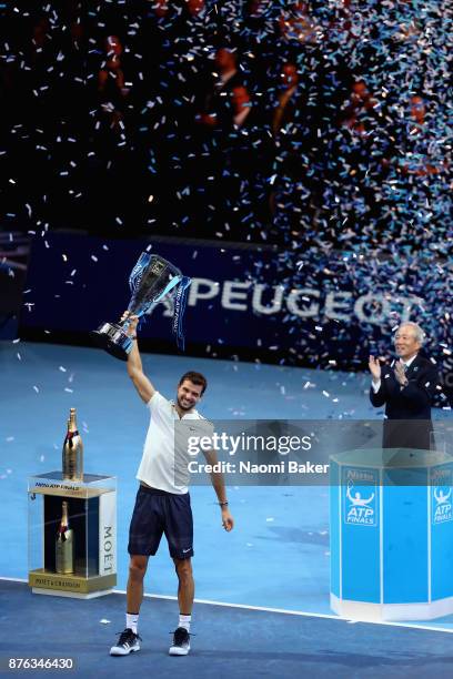 Grigor Dimitrov of Bulgaria lifts the trophy following victory in the mens singles final against David Goffin of Belgium during day eight of the 2017...