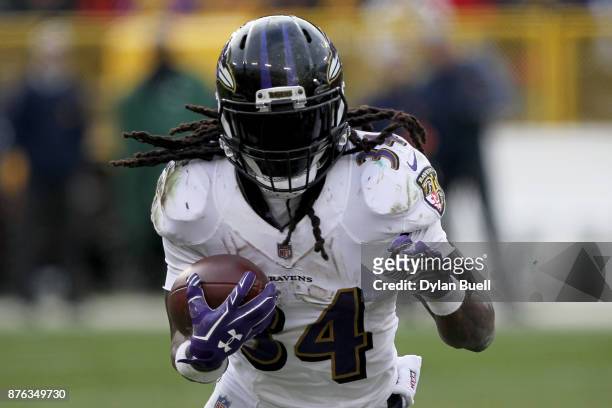 Alex Collins of the Baltimore Ravens runs with the ball in the fourth quarter against the Green Bay Packers at Lambeau Field on November 19, 2017 in...