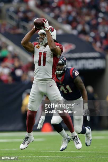 Larry Fitzgerald of the Arizona Cardinals catches a pass in the fourth quarter defended by Zach Cunningham of the Houston Texans at NRG Stadium on...