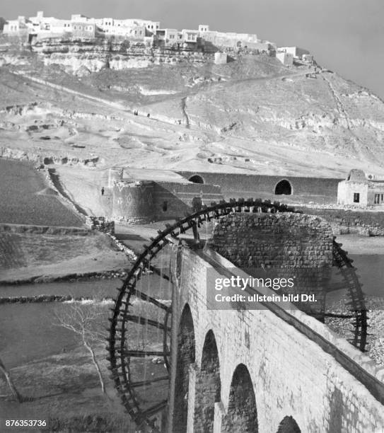 Old Romam water supply system at the Orontes river, a typical water wheel in the foreground