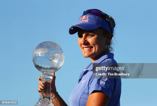 Lexi Thompson of the United States poses with the CME Race for the Globe trophy after the final round of the CME Group Tour Championship at the...