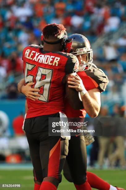 Patrick Murray celebrates with Kwon Alexander of the Tampa Bay Buccaneers after kicking the game winning field goal during the fourth quarter against...