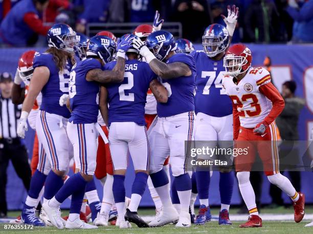 Aldrick Rosas of the New York Giants is congratulated by teammates Evan Engram and Jon Halapio of the New York Giants after Rosas kicked the game...