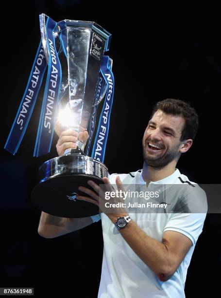 Grigor Dimitrov of Bulgaria lifts the trophy as he celebrates victory following the singles final against David Goffin of Belgium during day eight of...