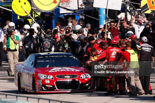 Dale Earnhardt Jr., driver of the AXALTA Chevrolet, is greeted by crew members as he drives on pit road prior to the Monster Energy NASCAR Cup Series...