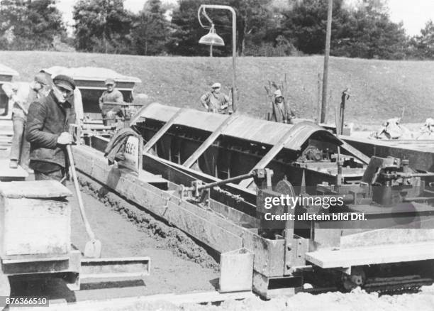 Road works with the help of construction machines, concrete compactor at building site in Munich Vintage property of Ullstein Bild