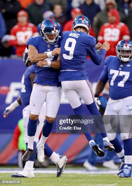 Aldrick Rosas of the New York Giants celebrates his field goal with teammate Brad Wing in the fourth quarter against the Kansas City Chiefs on...