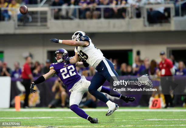 Tyler Higbee of the Los Angeles Rams and Harrison Smith of the Minnesota Vikings get tangled up while leaping for the ball in the second half of the...