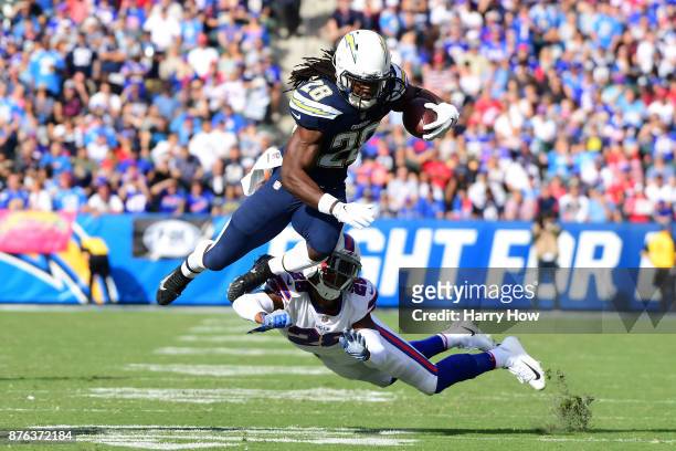 Melvin Gordon of the Los Angeles Chargers is hit by E.J. Gaines of the Buffalo Bills during the first half of the game at the StubHub Center on...