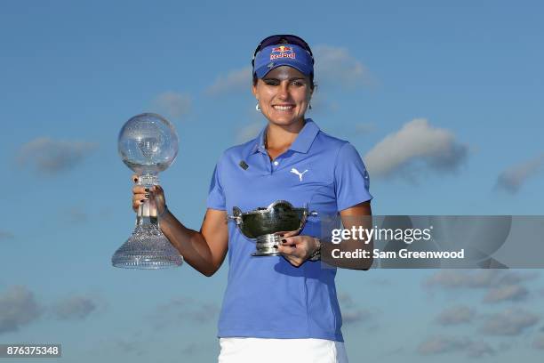 Lexi Thompson of the United States poses with the CME Race for the Globe trophy and the Vare trophy after the final round of the CME Group Tour...