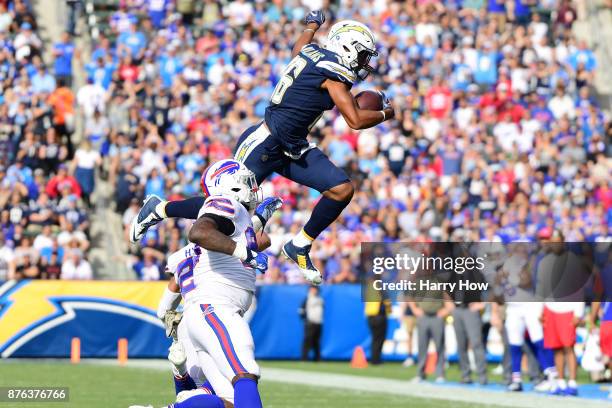 Tyrell Williams of the Los Angeles Chargers leaps over Micah Hyde of the Buffalo Bills during the game at the StubHub Center on November 19, 2017 in...