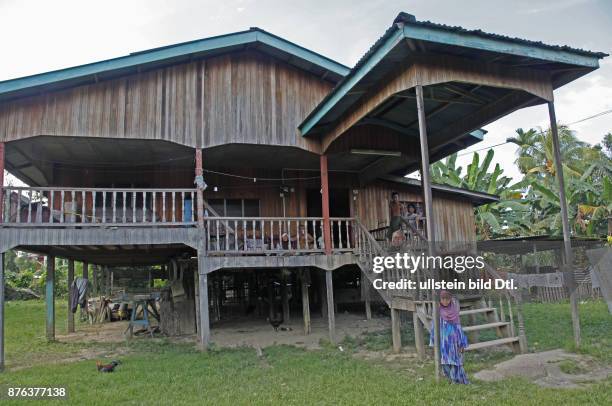 Traditional native Iban and Dayak family in a longhouse in Borneo, Malaysia